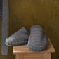 Grey Swell organic cotton slippers with a cozy, soft texture, displayed to showcase their comfort and minimalist design.