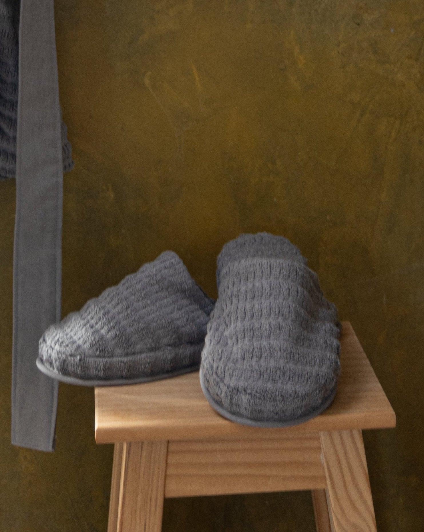 Grey Swell organic cotton slippers with a cozy, soft texture, displayed to showcase their comfort and minimalist design.