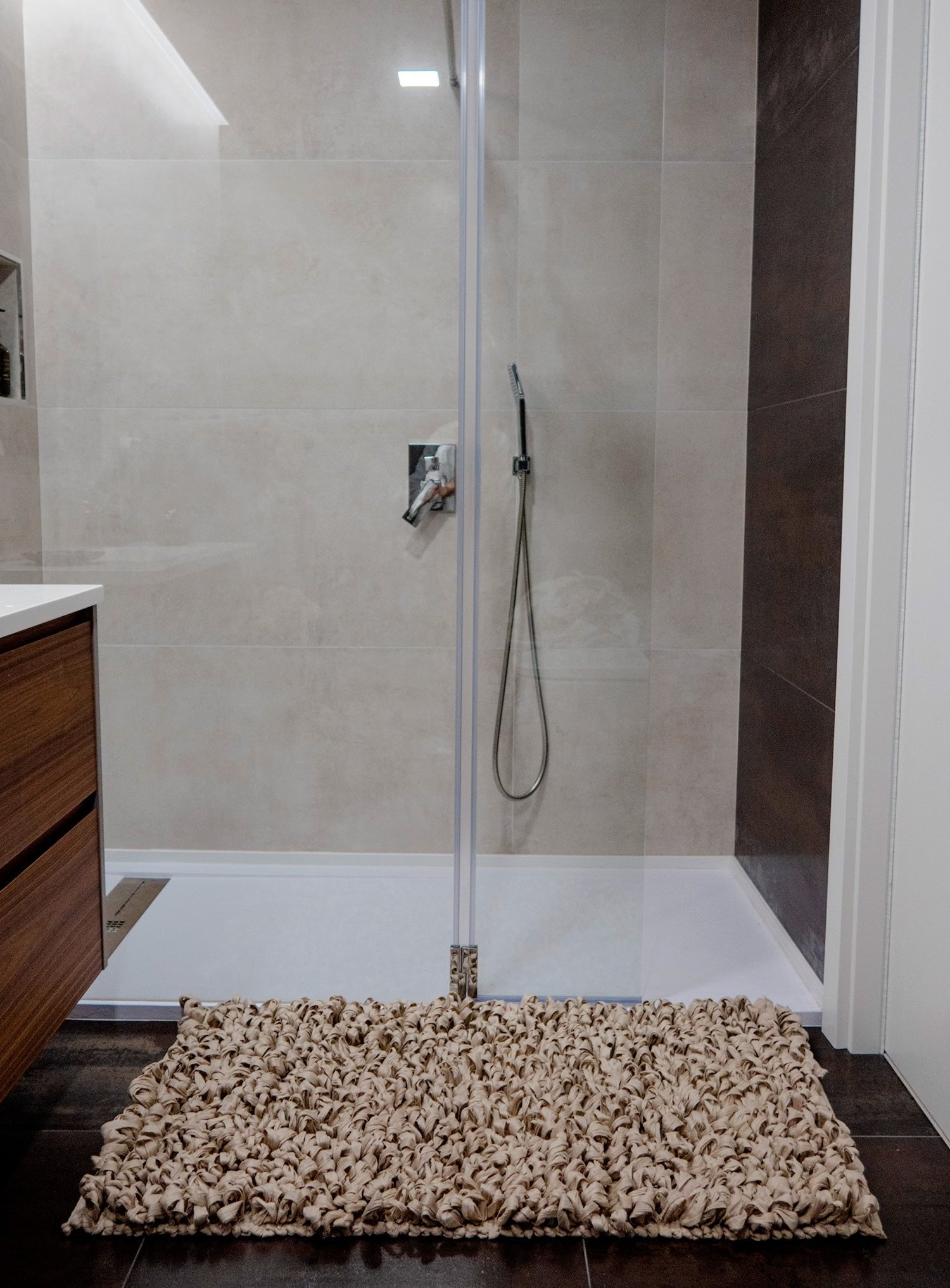 Bathmate from the HEAD in the Clouds collection in the color Under the Canopy. The bathmate features a soft, cushioned surface designed to evoke the feeling of stepping onto cool, soft grass. Made from upcycled textiles, it offers a comfortable and eco-friendly touch to your bathroom decor.