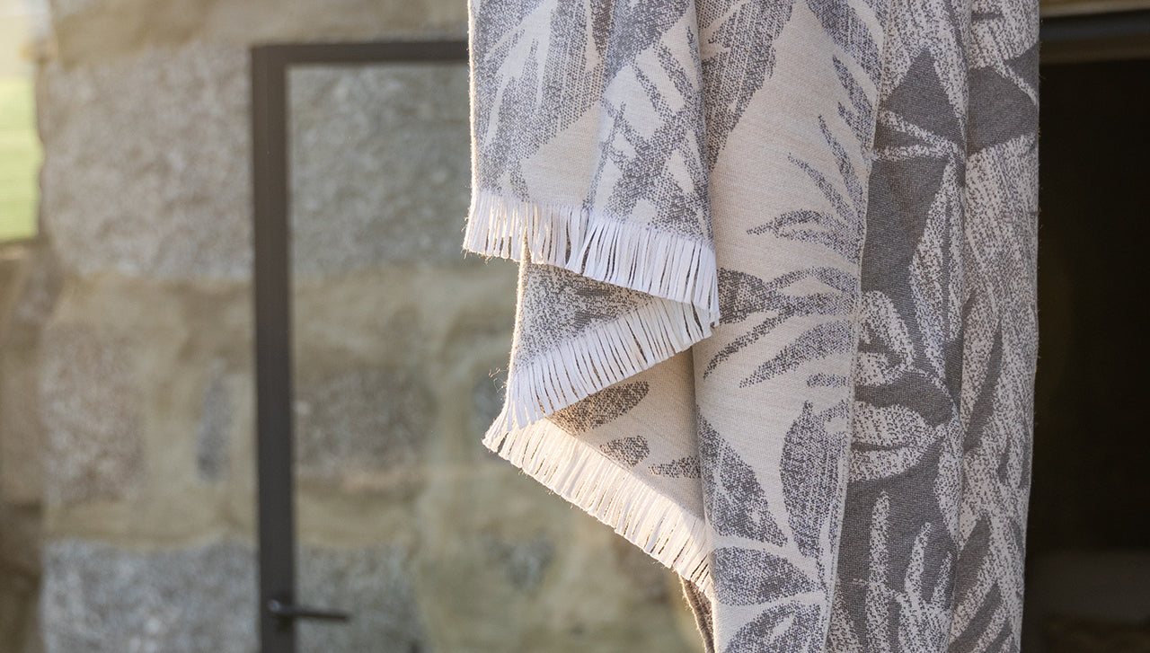 Photo displaying SOWL's floral premium 100% wool plaid, double-sided in light grey,