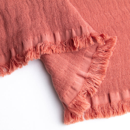 Juicy Organic Cotton Throw in coral - Vibrant and cozy throw blanket made from 100% organic cotton, perfect for adding warmth and a cheerful touch to your living space or king-size bedding.