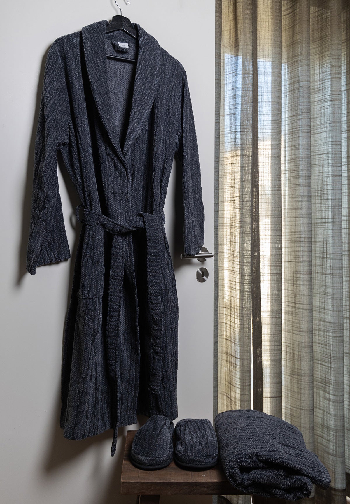 Sequoia organic cotton men's bathrobe in beige, displayed on a hanger, showcasing its plush texture and comfortable fit, perfect for lounging after a shower or bath.