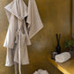 Beige Swell organic cotton bathrobe, featuring a luxurious and soft texture, perfect for ultimate comfort and relaxation.